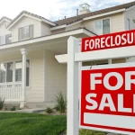 A "Foreclosure For Sale" sign stands in front of a house, raising the question: Can you foreclose on a life estate?