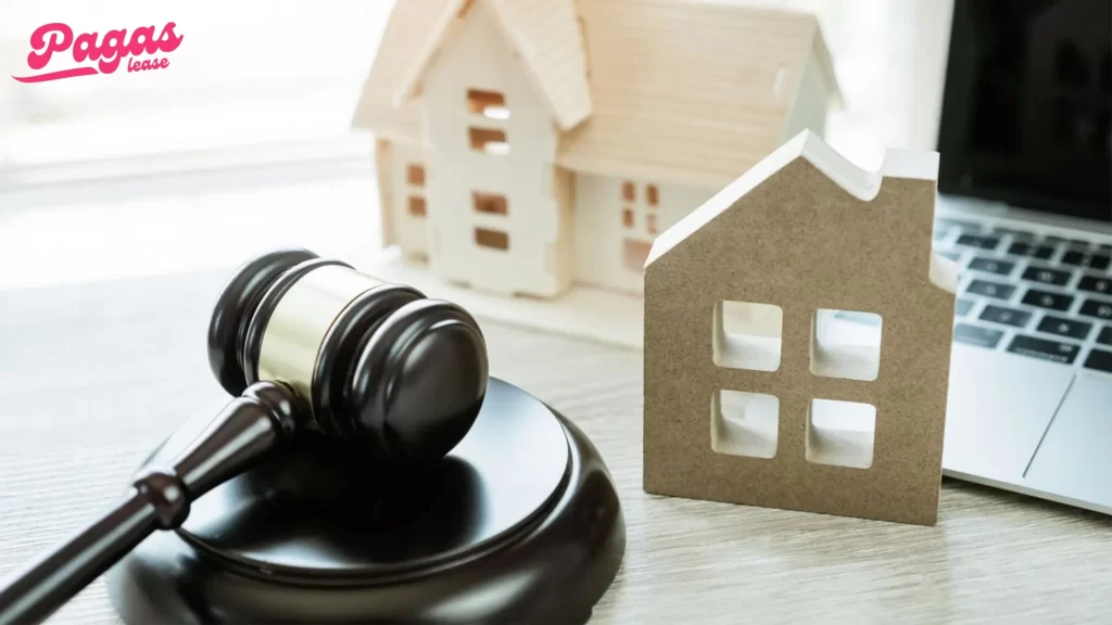 A gavel beside miniature house models and a laptop, highlighting the legal aspects and raising the question: Can you foreclose on a life estate?